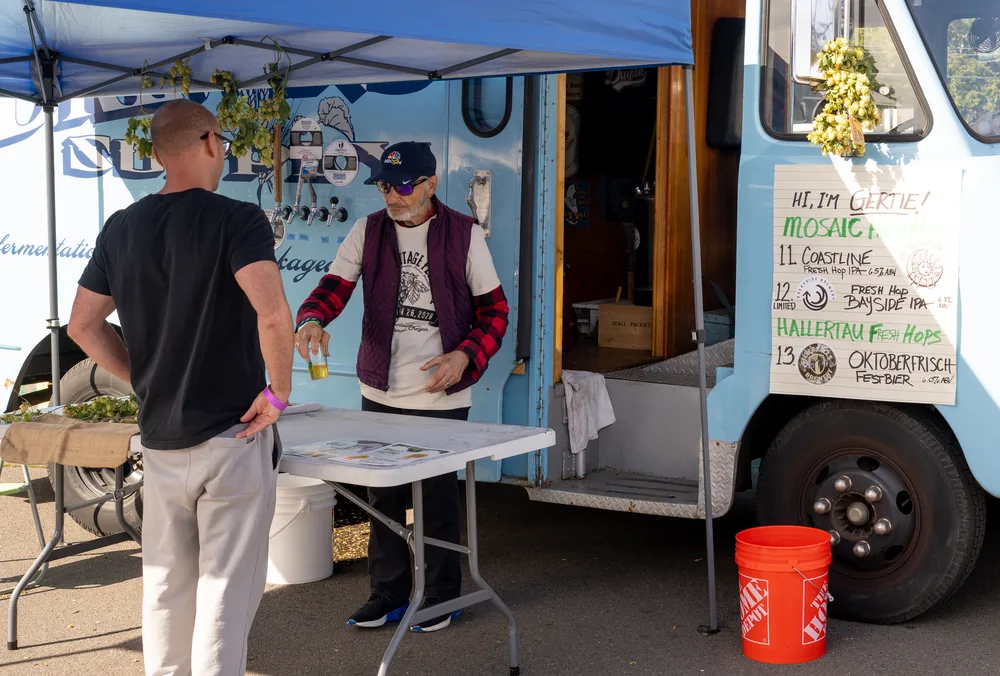 A brewer pouring fresh hop beer at the Hop Truck Bar at the Fresh Hop Fiesta